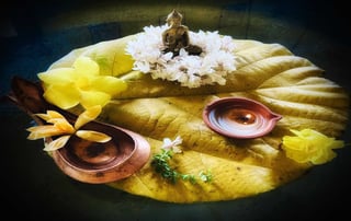 A puja offering with lamps and flowers